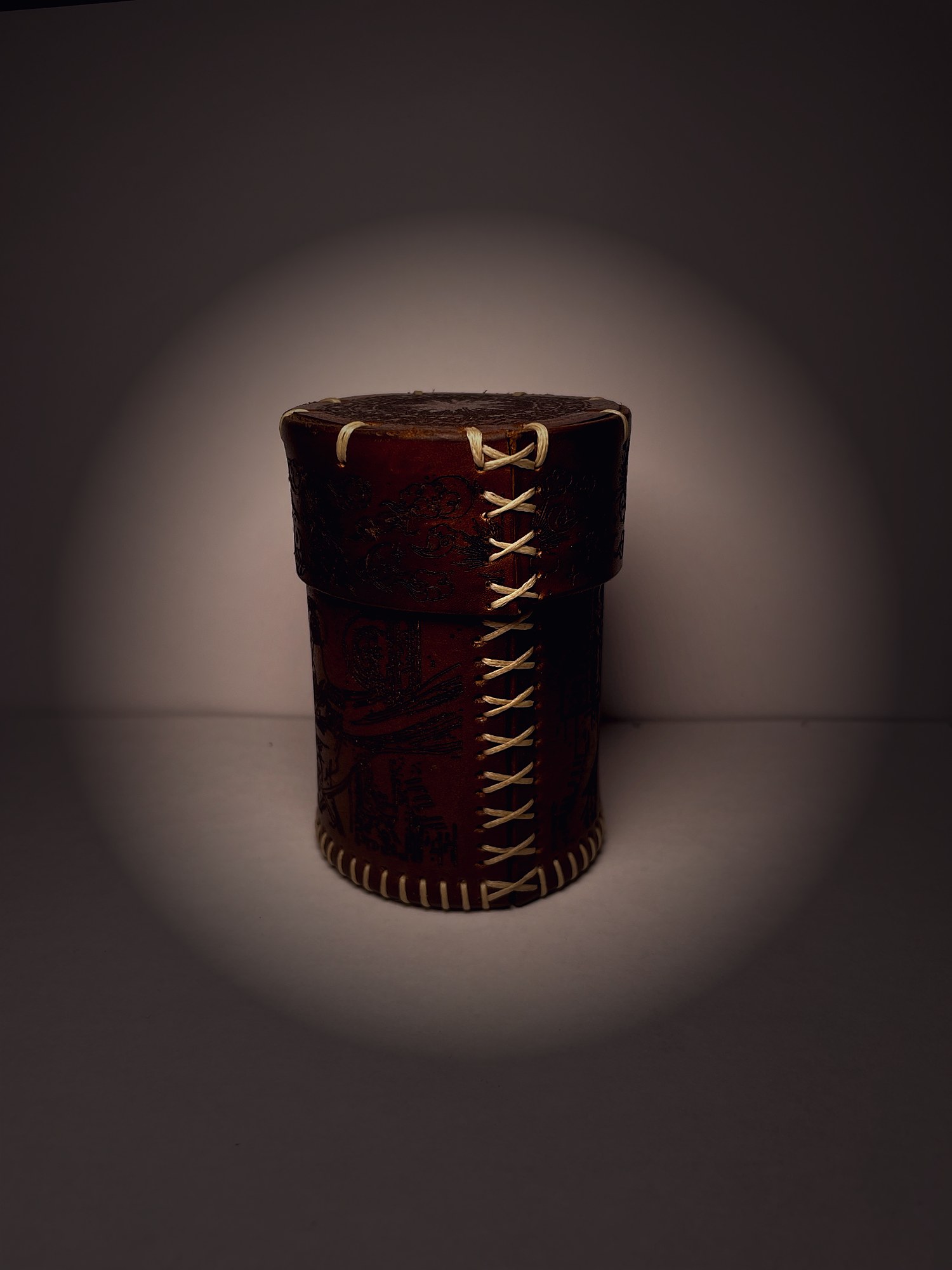 Leather dice cup with engraved lid standing upright — full product view