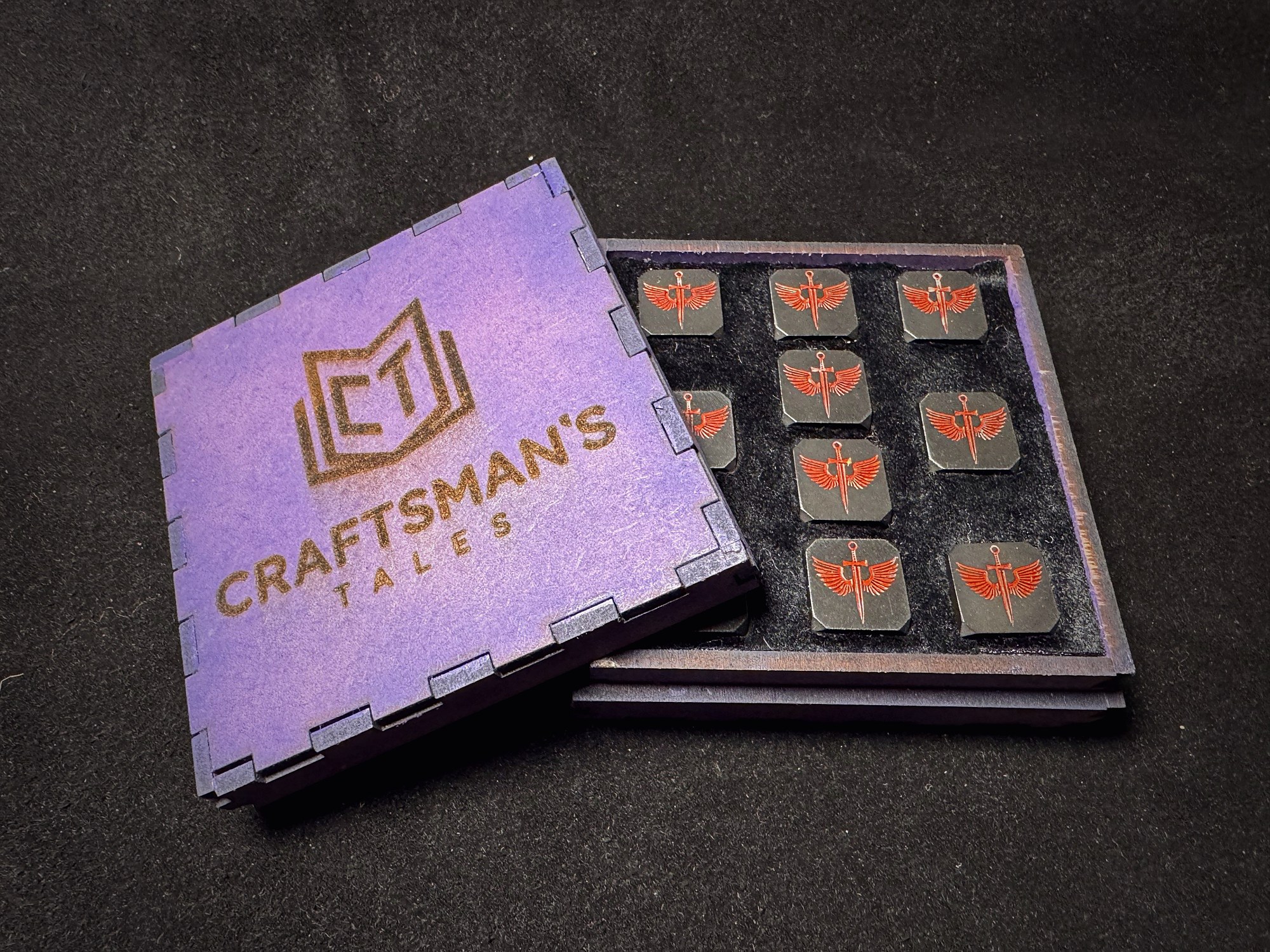 Open Craftsman's Tales purple branded wooden box revealing custom engraved stamps inside